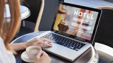 Frau vor Laptop will Urlaub buchen