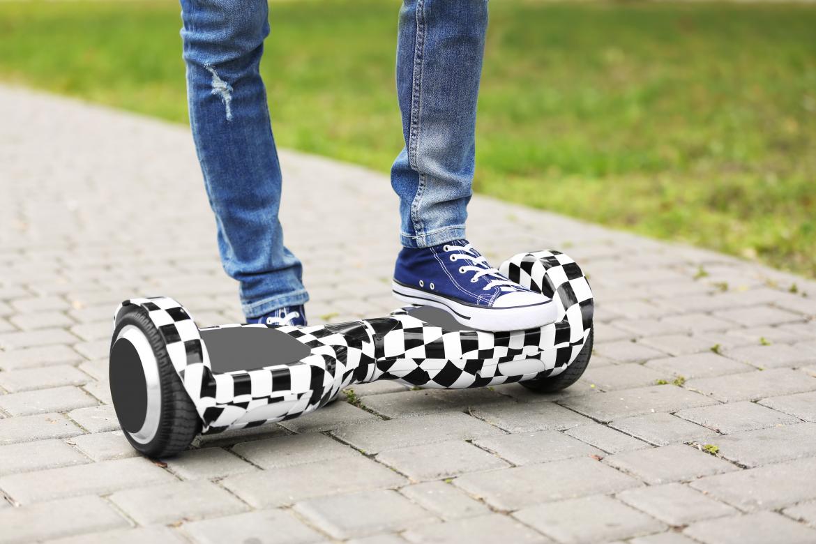 Füße einer Jugendlichen auf Hoverboard. 